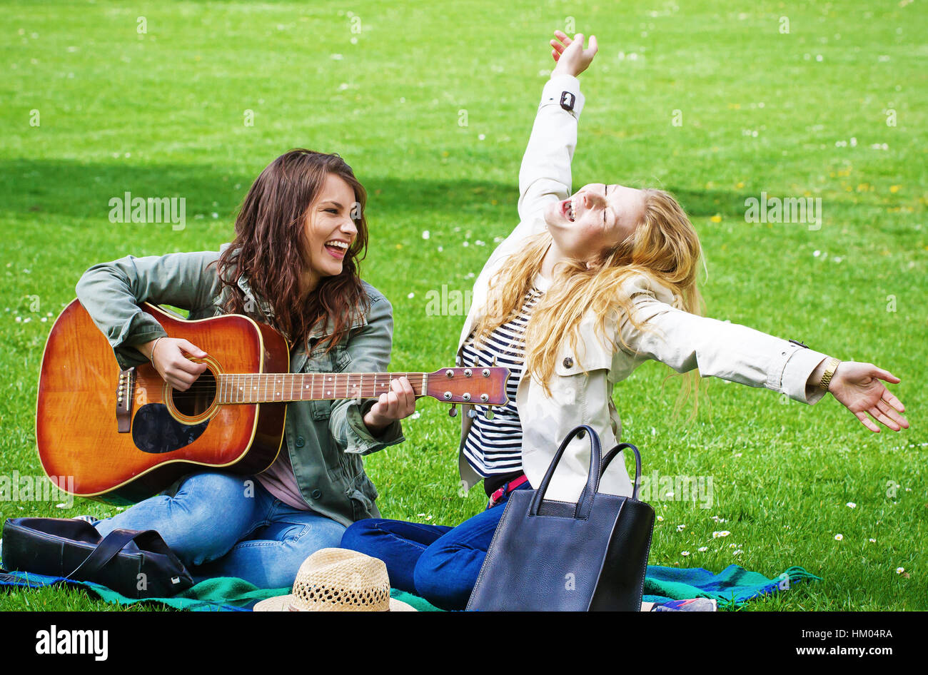 Girls making music in the park Stock Photo