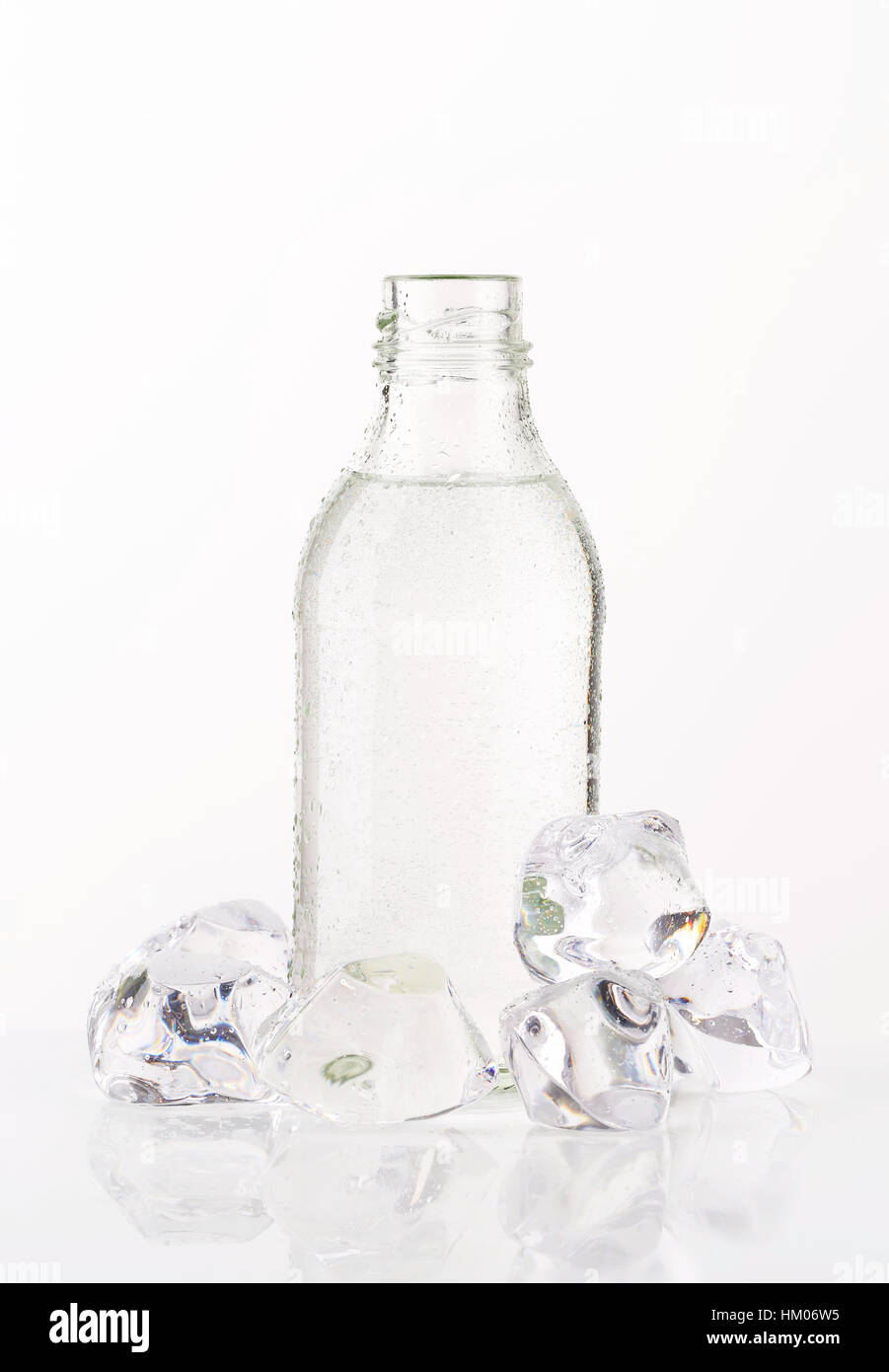 bottle of fresh water and ice cubes on white background Stock Photo - Alamy