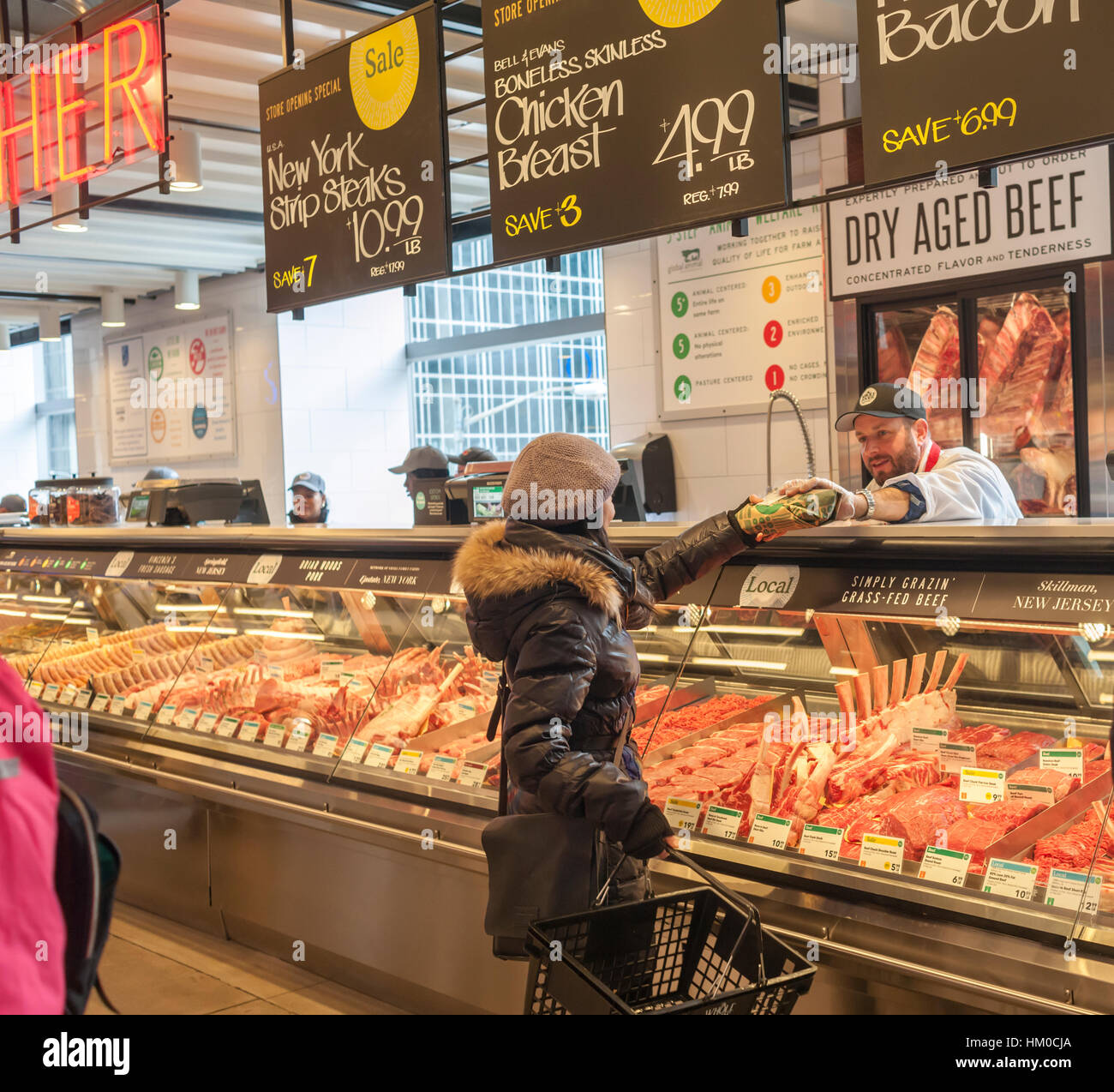 https://c8.alamy.com/comp/HM0CJA/a-shopper-chooses-cuts-of-meat-in-the-new-whole-foods-market-opposite-HM0CJA.jpg