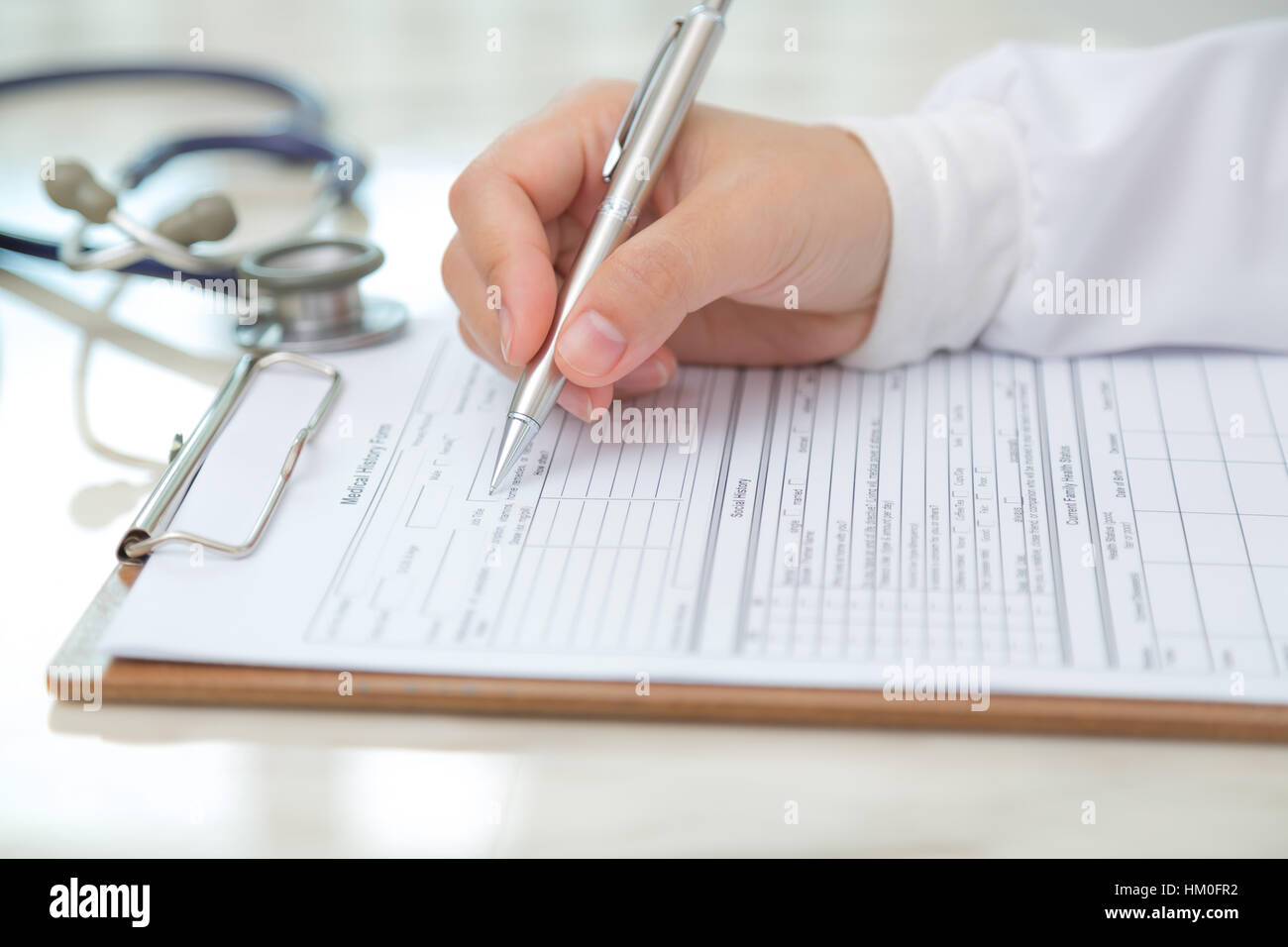 Hand of doctor writing on prescription Stock Photo - Alamy