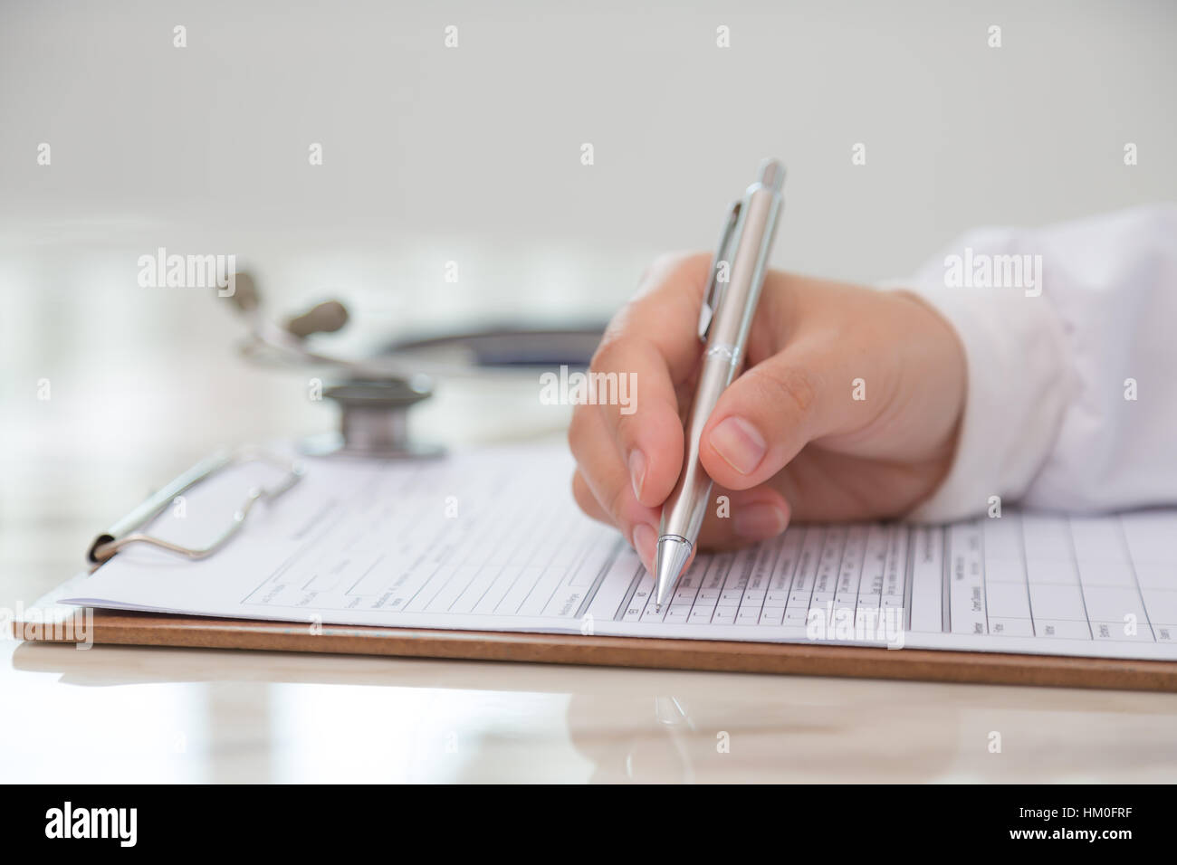 Hand of doctor writing on prescription Stock Photo - Alamy