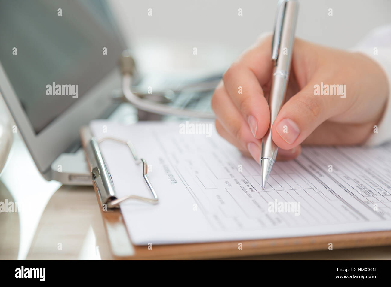 Hand of doctor writing on prescription Stock Photo - Alamy