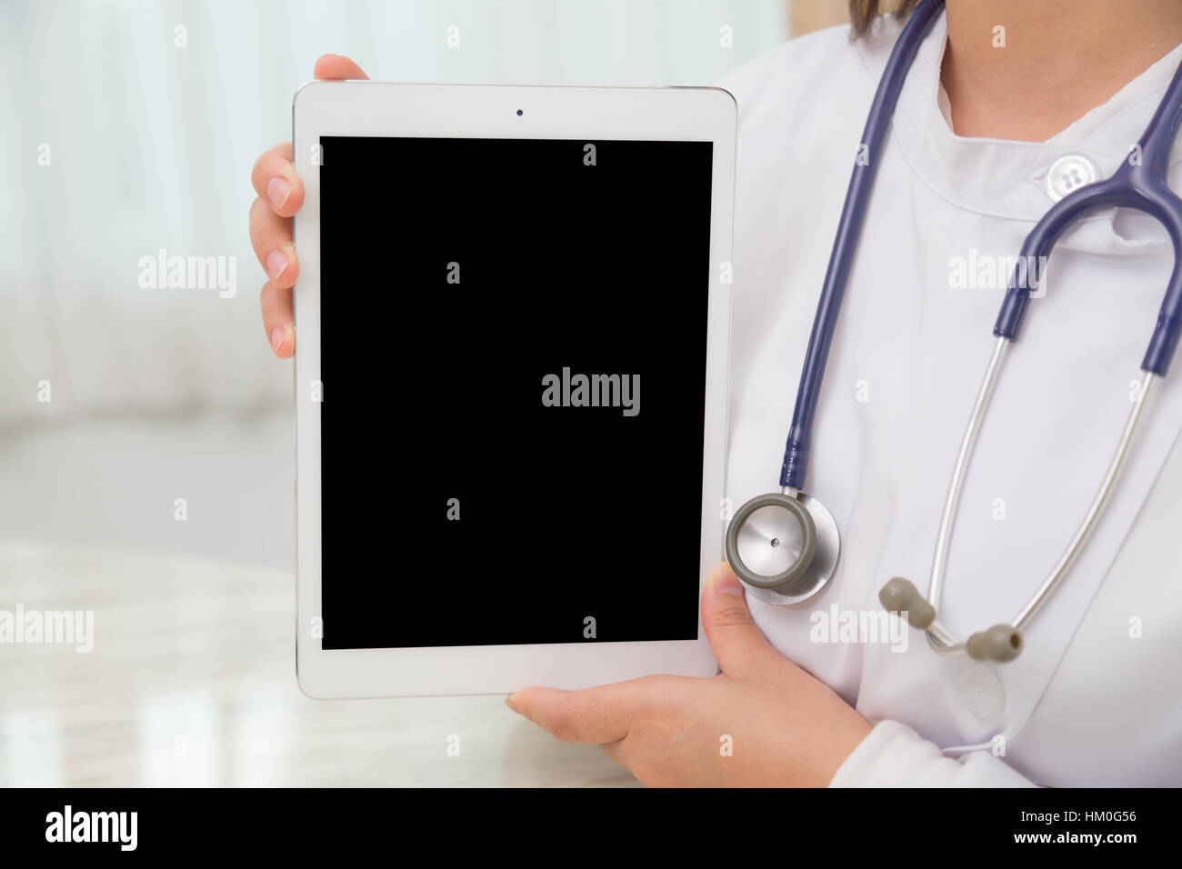 Doctor using tablet computer Stock Photo - Alamy