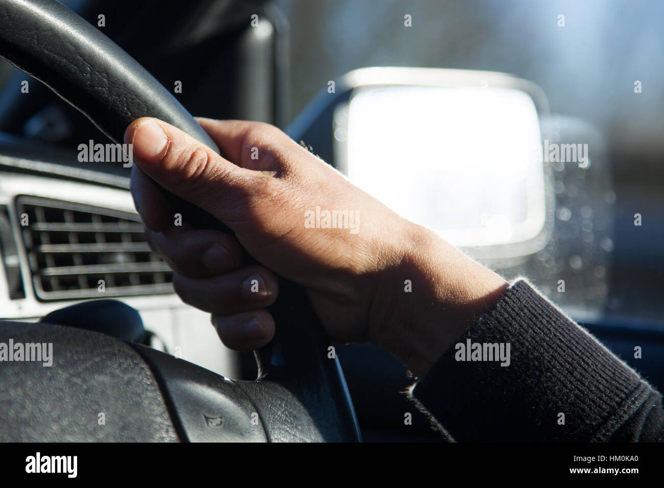 male hands on wheel driving a car Stock Photo Alamy