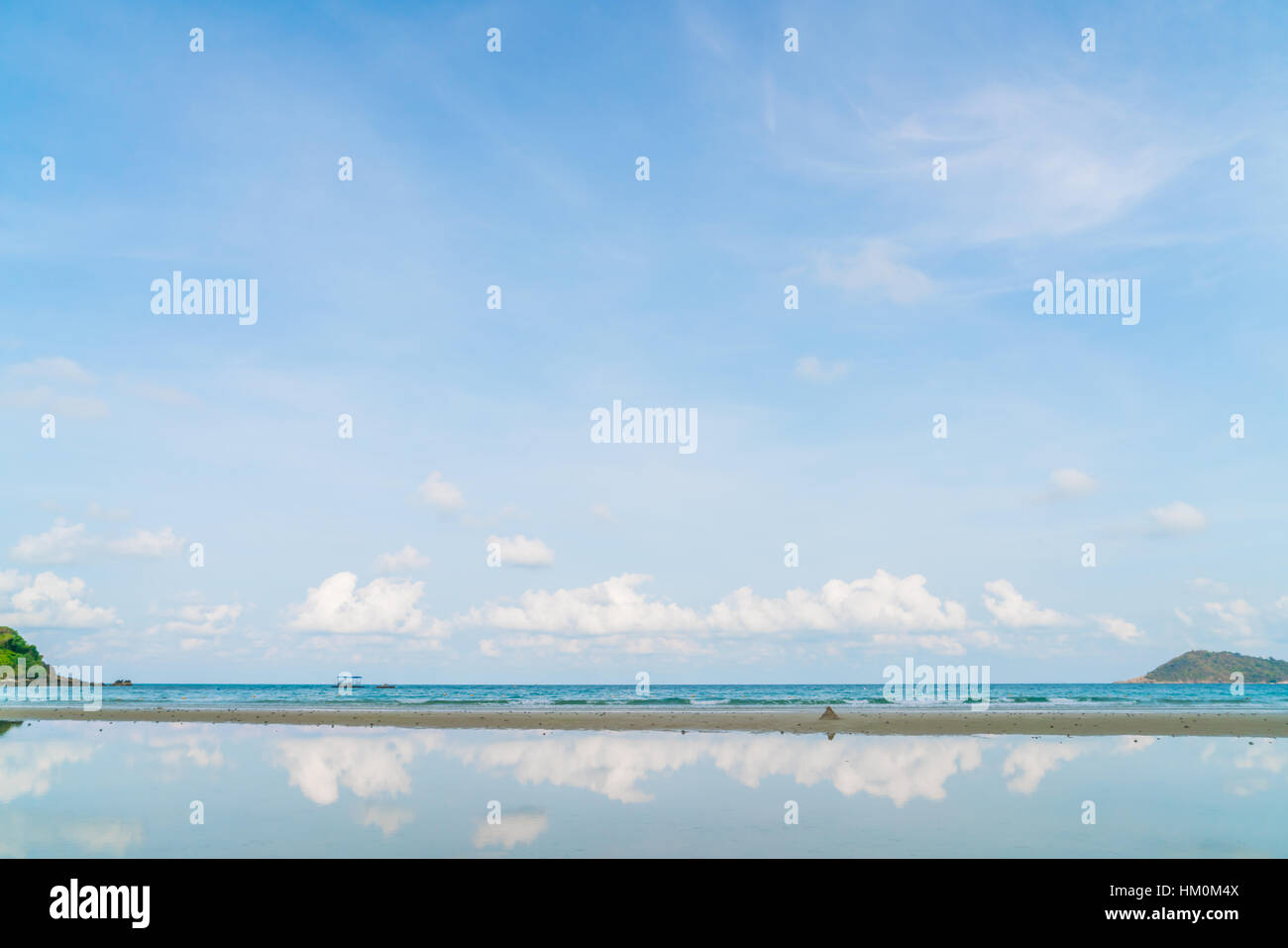 Beautiful white sand beach with blue sea and sky Stock Photo - Alamy
