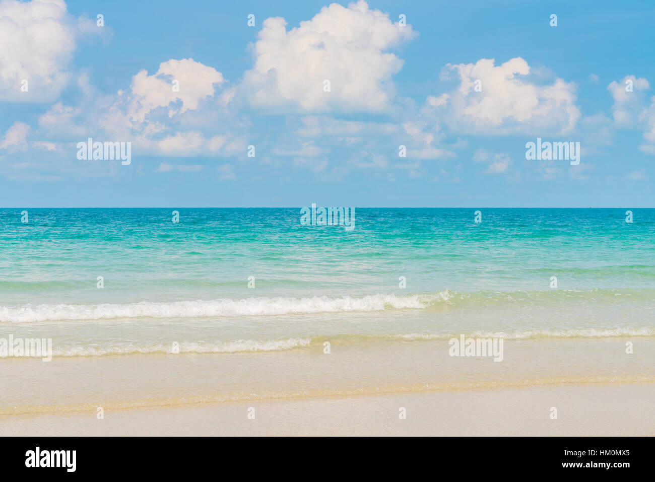 Beautiful white sand beach with blue sea and sky Stock Photo - Alamy