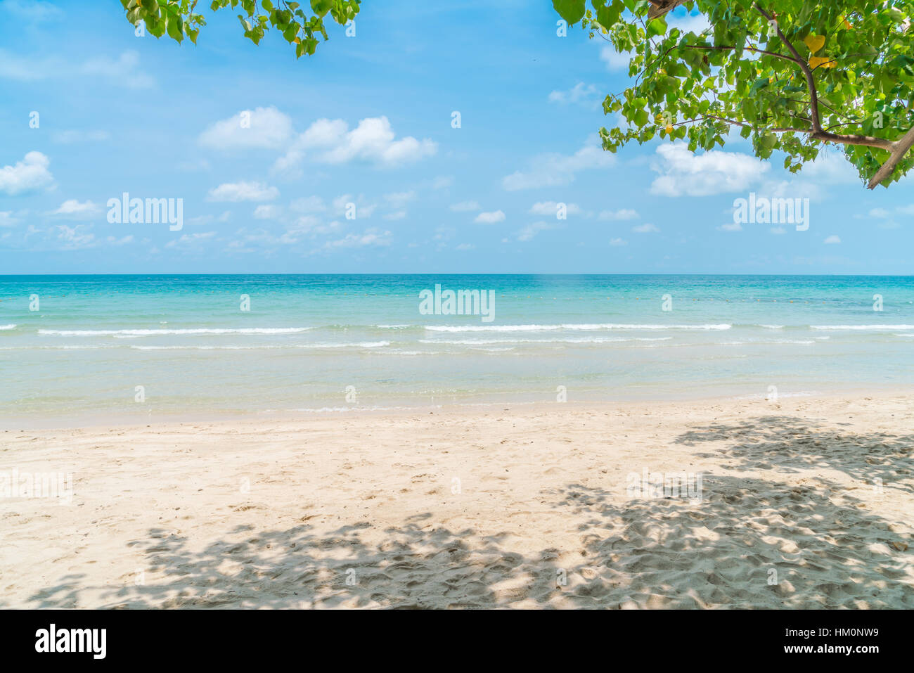 Beautiful white sand beach with blue sea and sky Stock Photo - Alamy