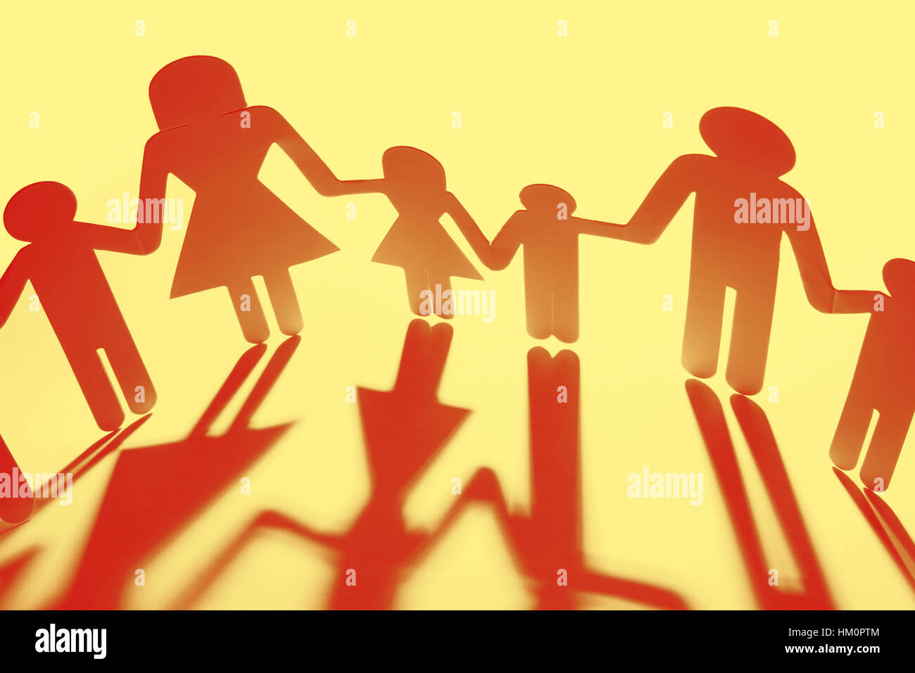 Family paper chain cutout holding hands Stock Photo - Alamy