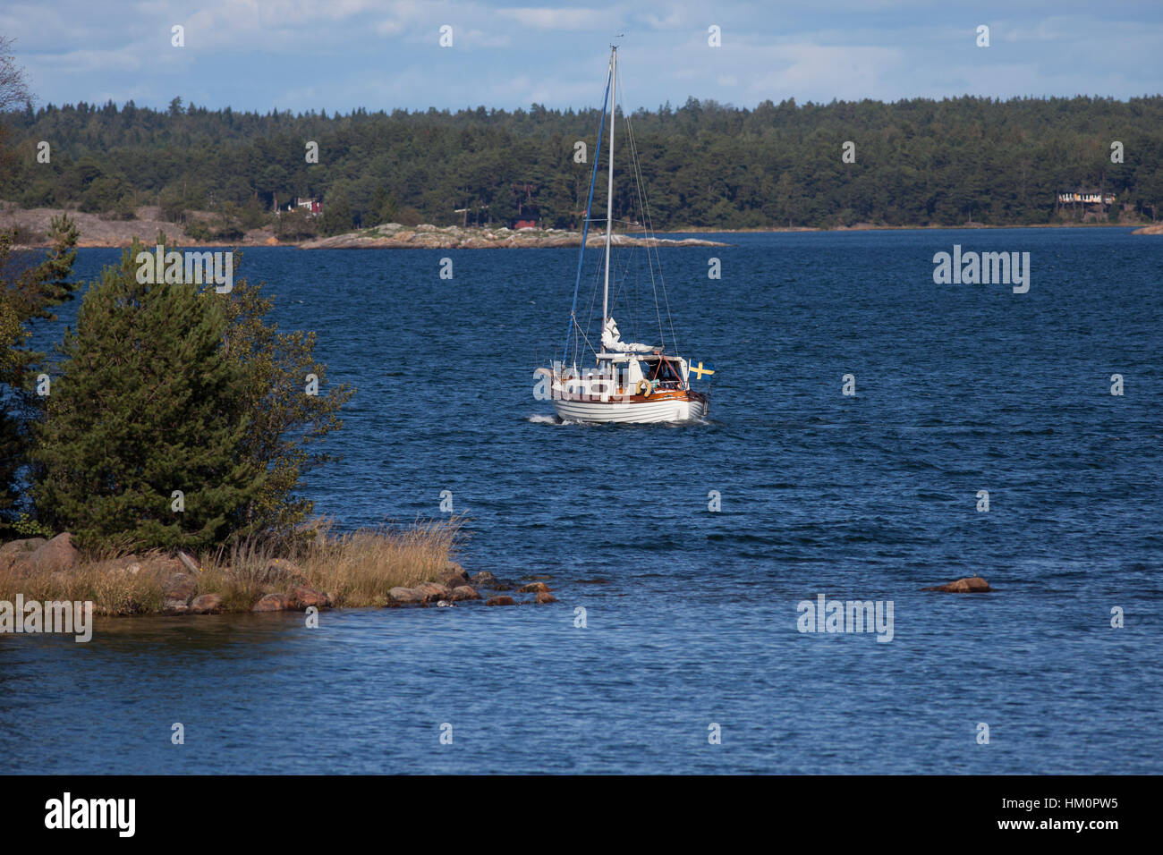 Wooden boat with family on vacation in the Swedish archipelago Stock Photo