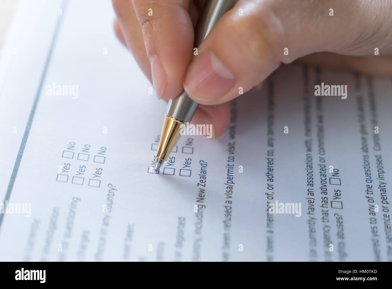 Hand with pen over application form Stock Photo - Alamy