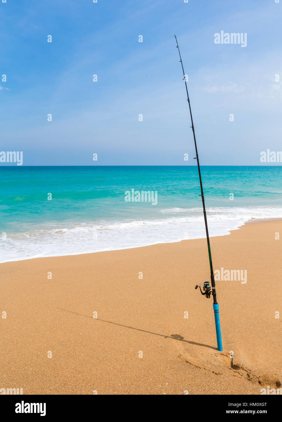 Fishing rod in sand of tropical beach Stock Photo - Alamy