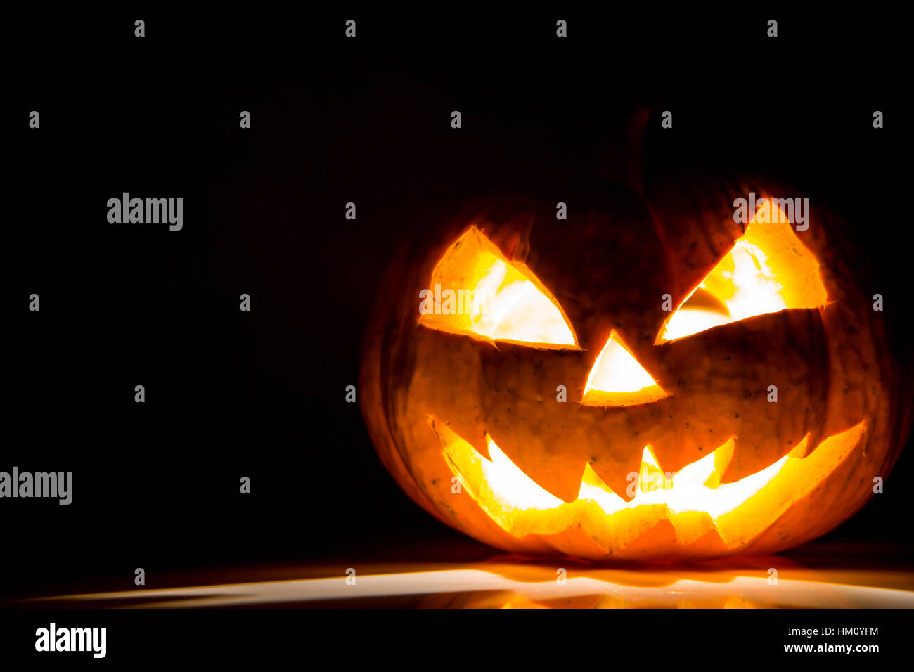 Halloween scary face pumpkin on black background Stock Photo - Alamy