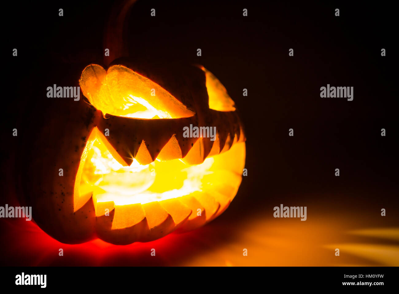 Halloween scary face pumpkin on black background Stock Photo - Alamy