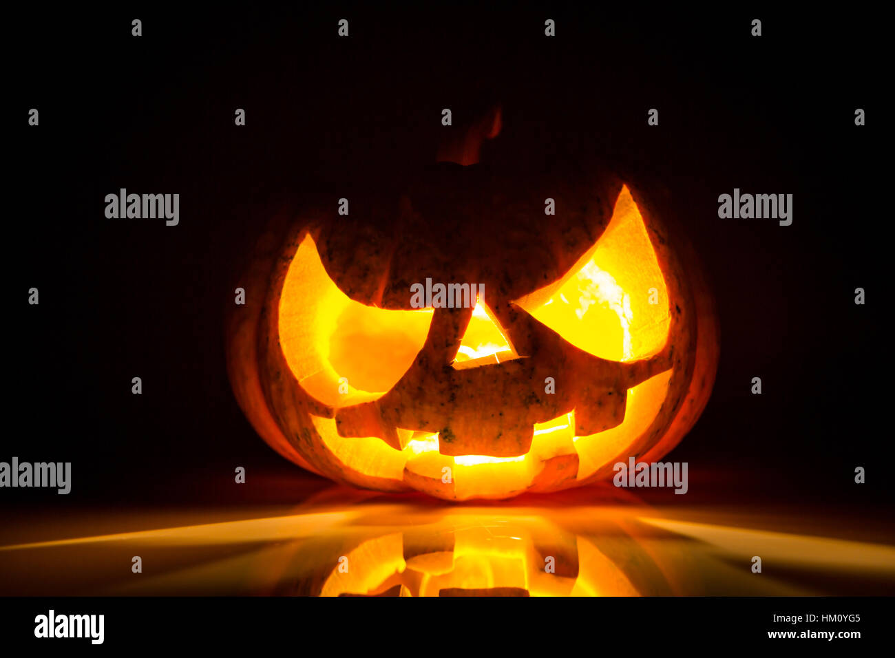 Halloween scary face pumpkin on black background Stock Photo - Alamy