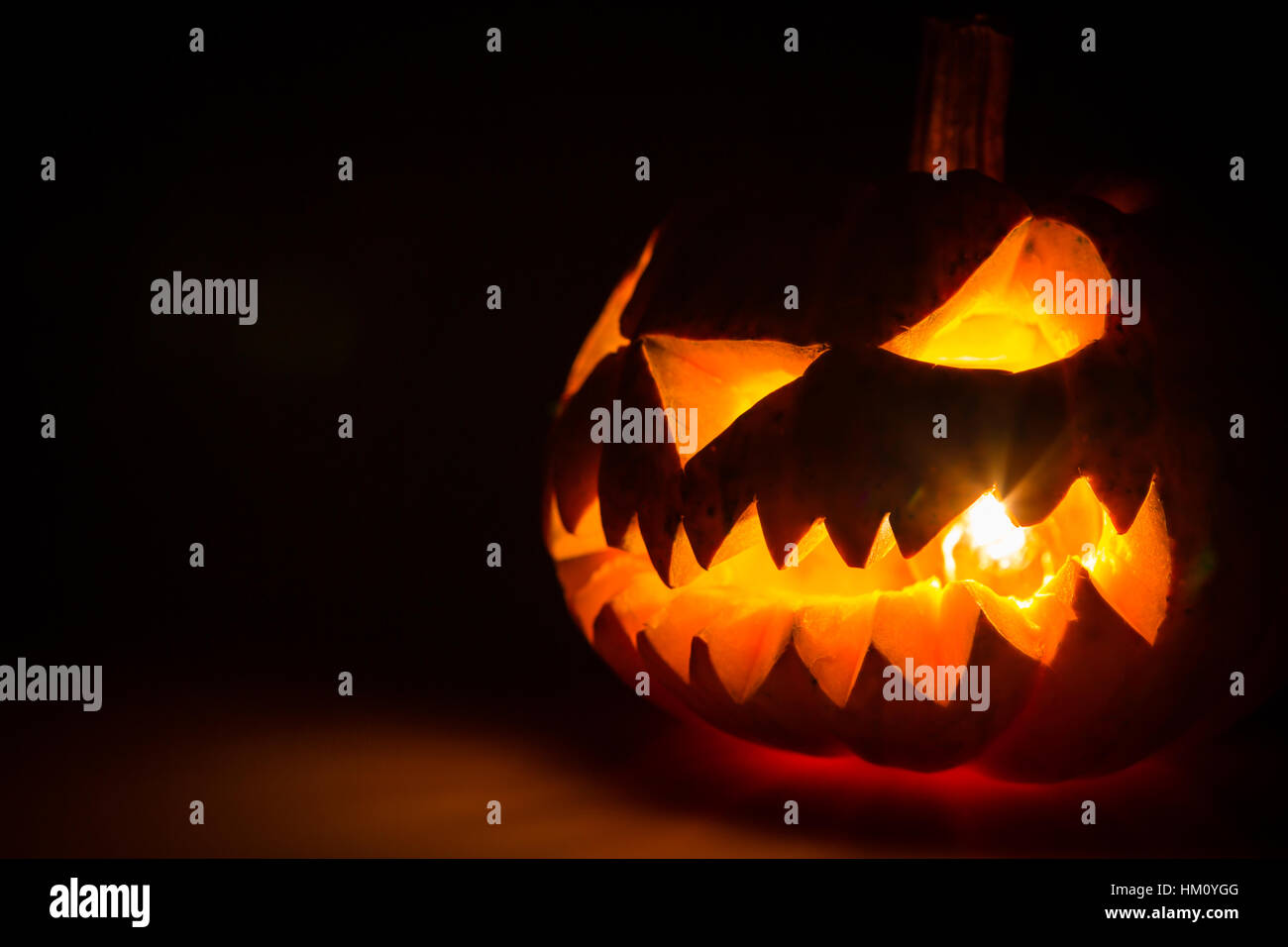 Halloween scary face pumpkin on black background Stock Photo - Alamy