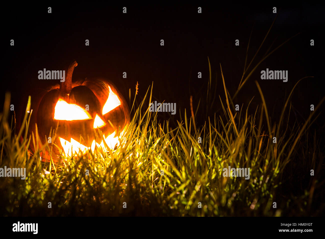 Halloween scary face pumpkin on black background Stock Photo - Alamy