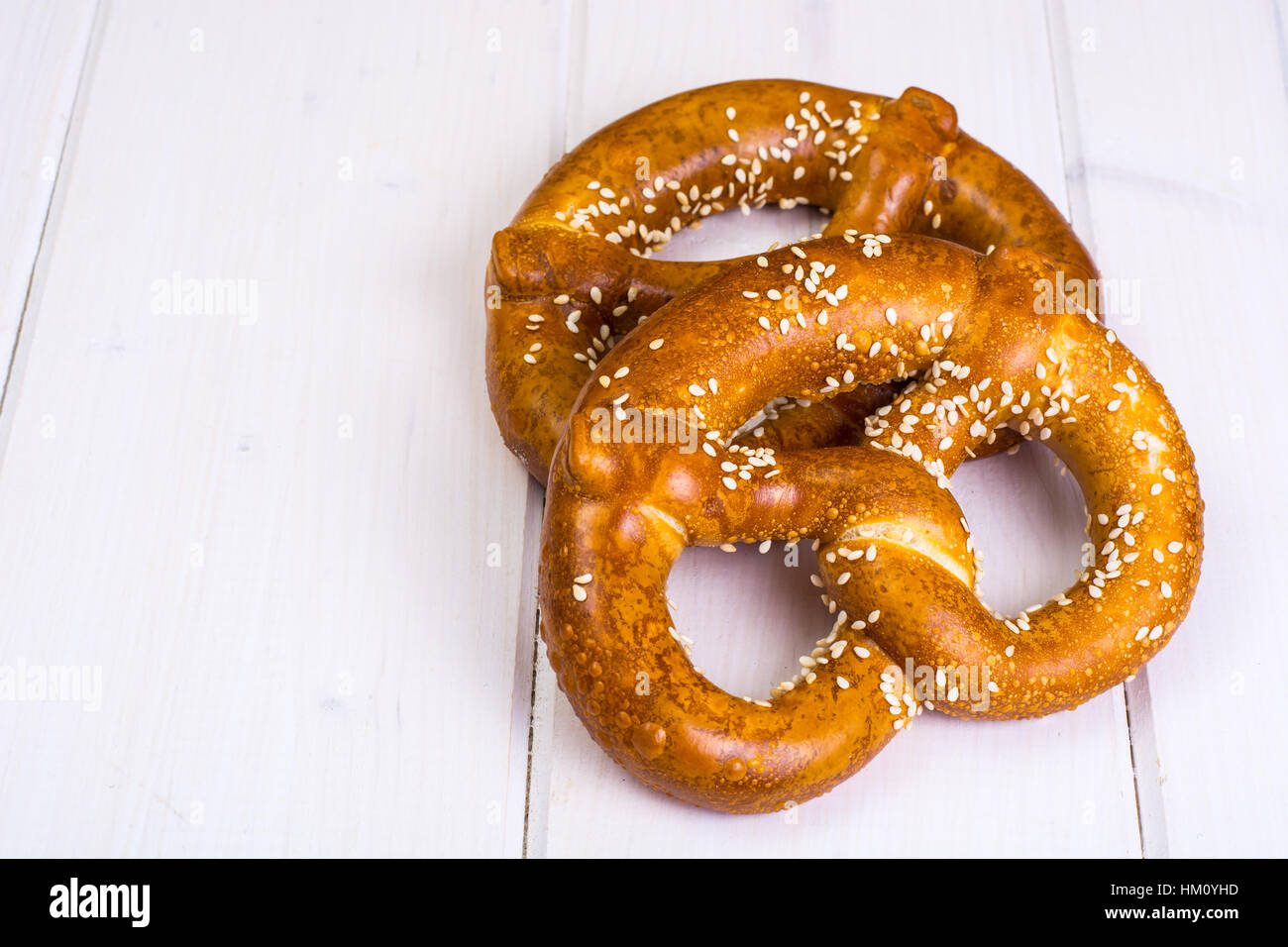 Bavarian pretzels with sesame seeds on white boards Stock Photo Alamy