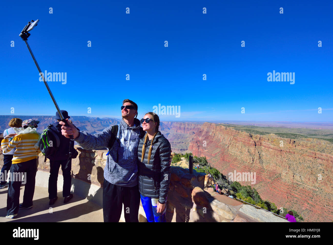 Couple taking selfy photographs, Grand Canyon National Park South Rim at Desert View Watchtower visitors viewpoint Stock Photo