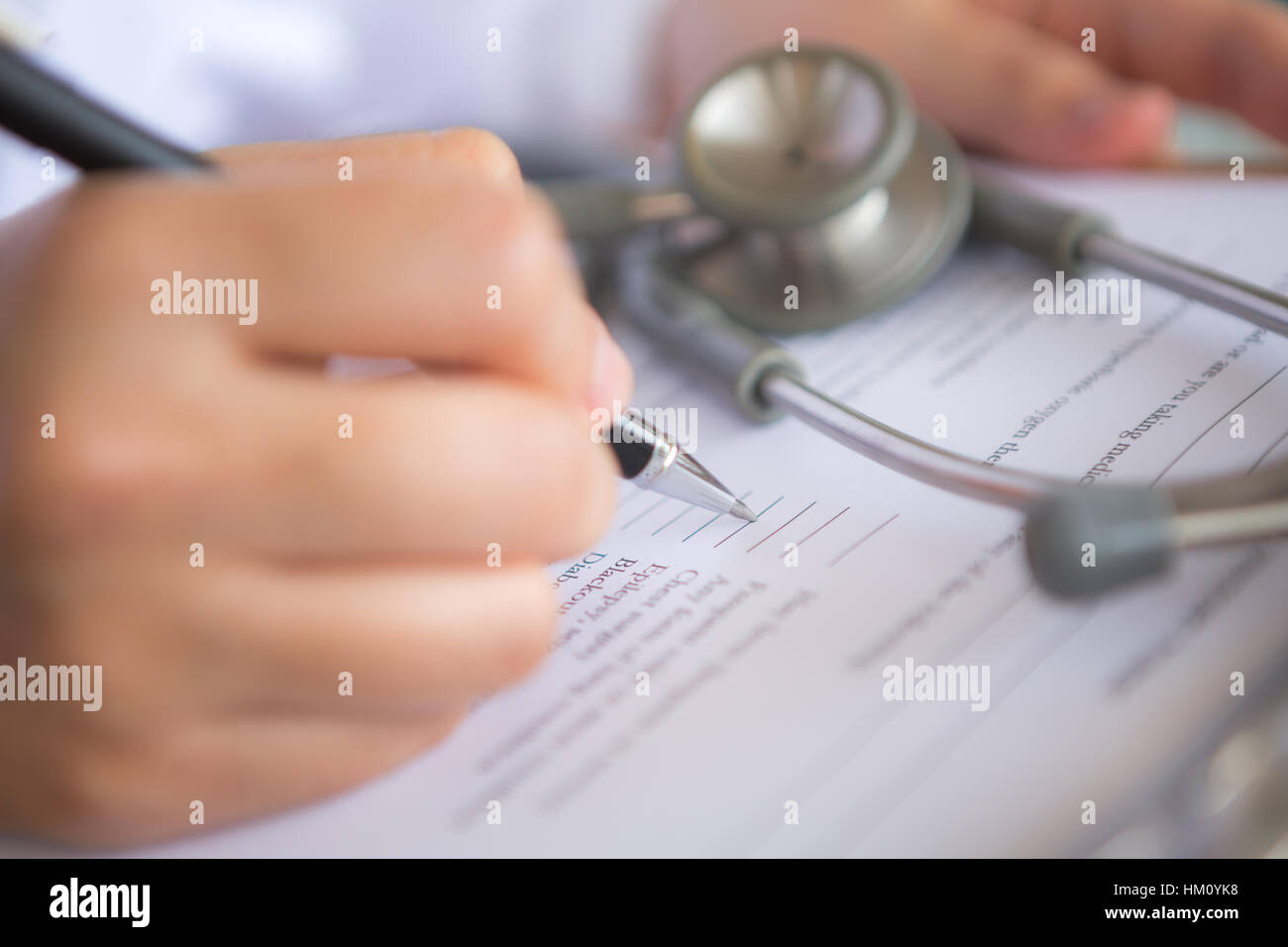 Hand of doctor writing on prescription Stock Photo - Alamy