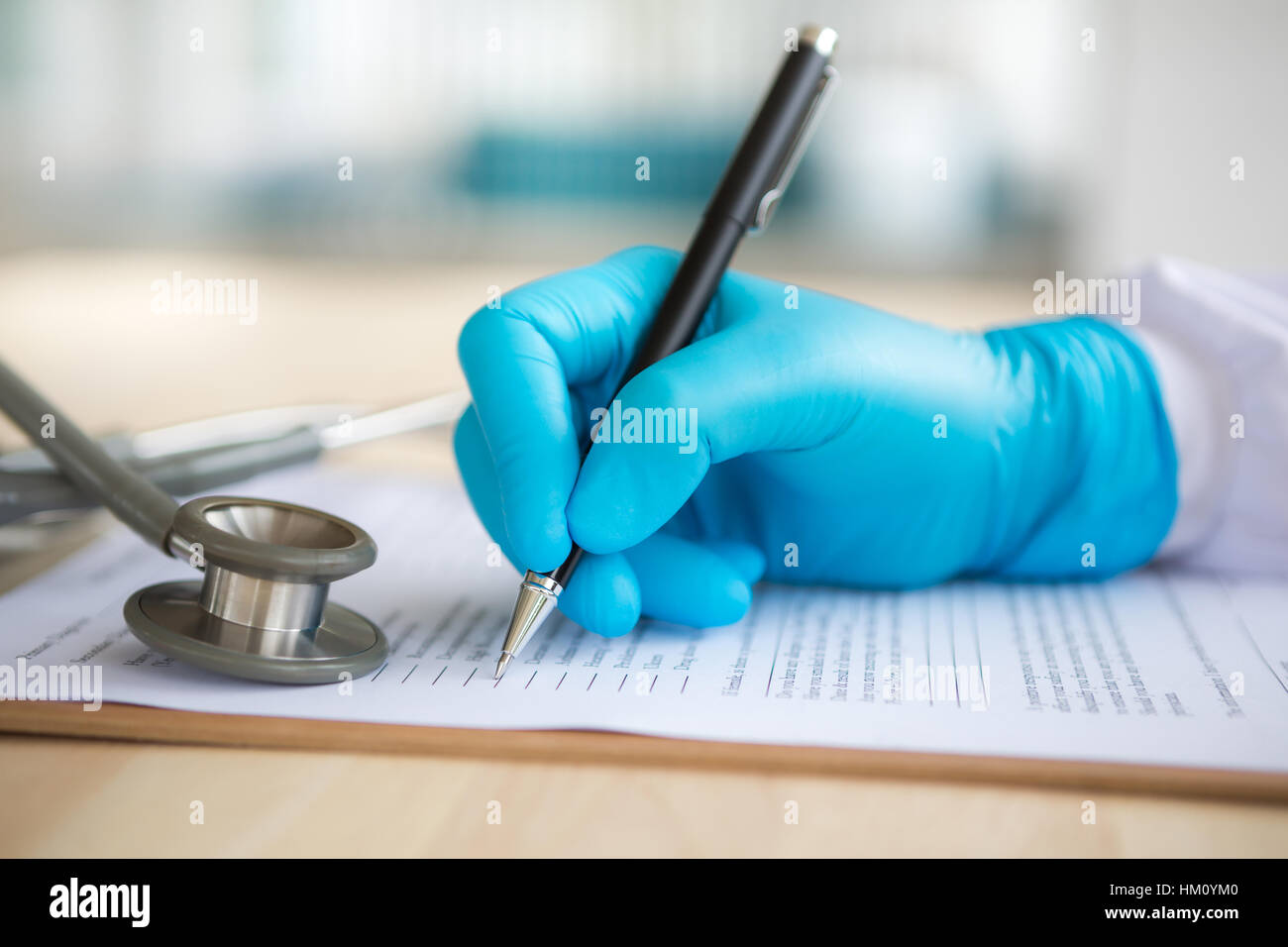 Hand of doctor writing on prescription Stock Photo - Alamy
