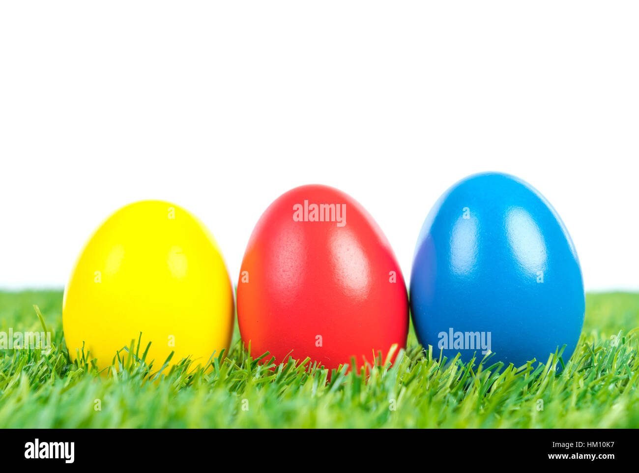 Easter Eggs on Fresh Green Grass over white background Stock Photo - Alamy