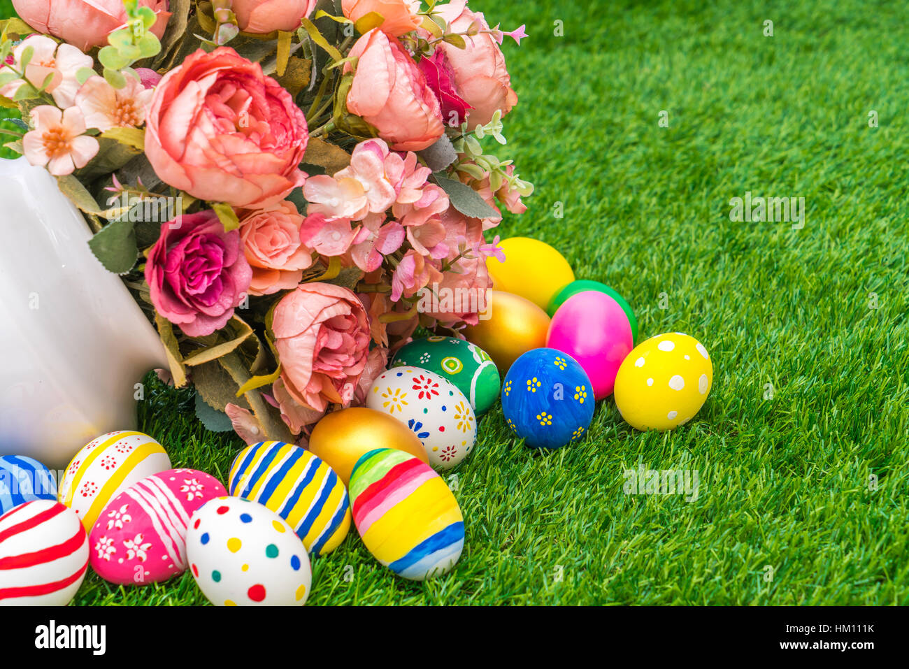 Easter eggs with artificial flower on Fresh Green Grass Stock Photo - Alamy