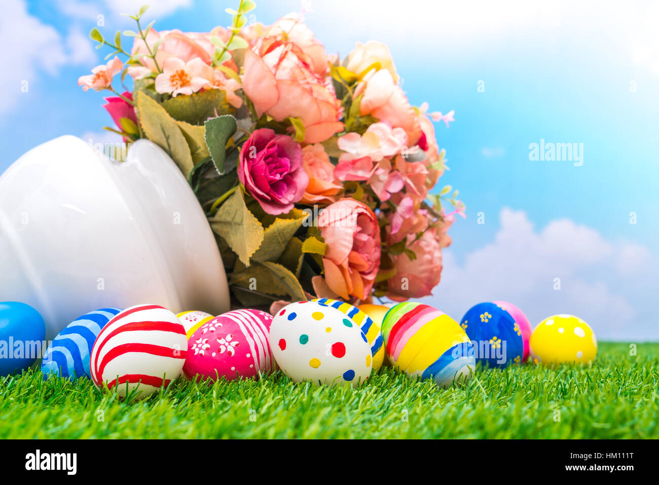 Easter eggs with artificial flower on Fresh Green Grass Stock Photo - Alamy