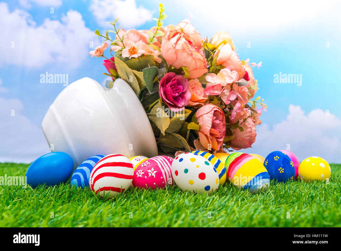 Easter eggs with artificial flower on Fresh Green Grass Stock Photo - Alamy