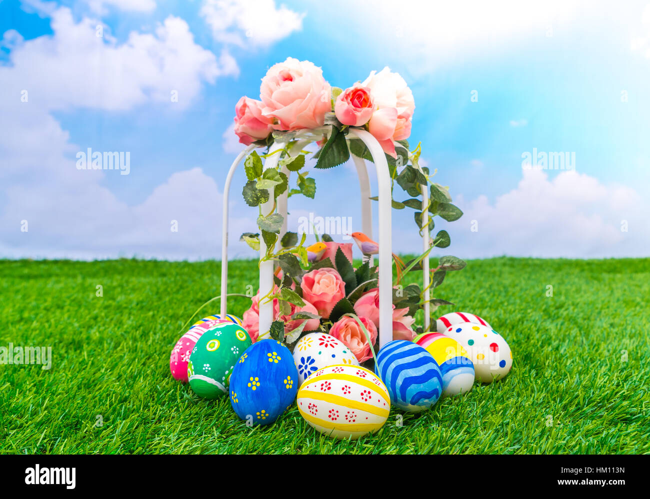 Easter eggs with artificial flower on Fresh Green Grass Stock Photo - Alamy