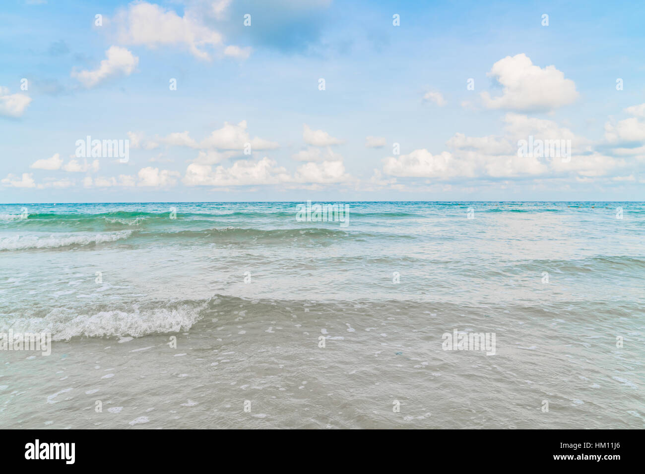 Beautiful white sand beach with blue sea and sky Stock Photo - Alamy