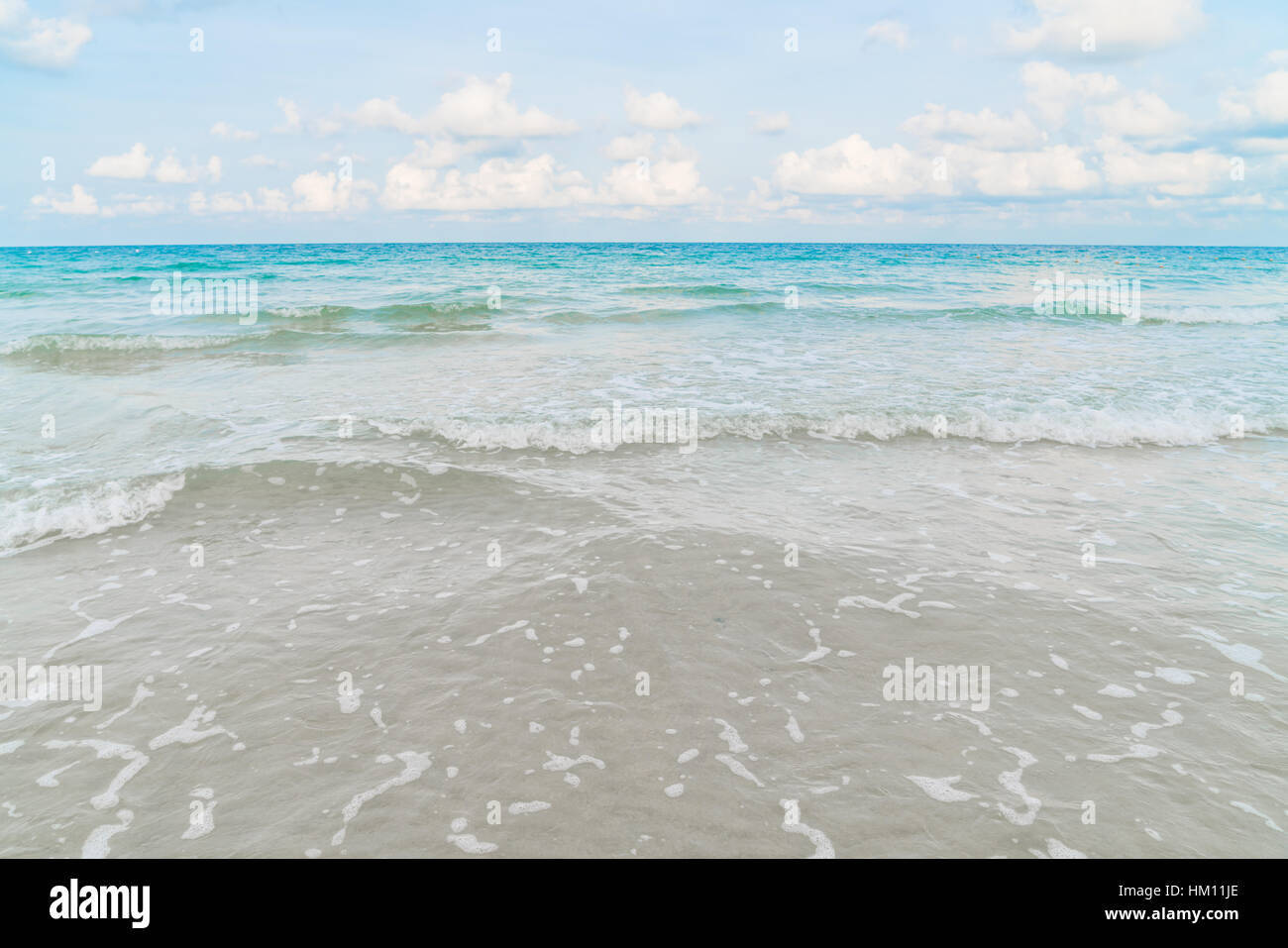 Beautiful white sand beach with blue sea and sky Stock Photo - Alamy