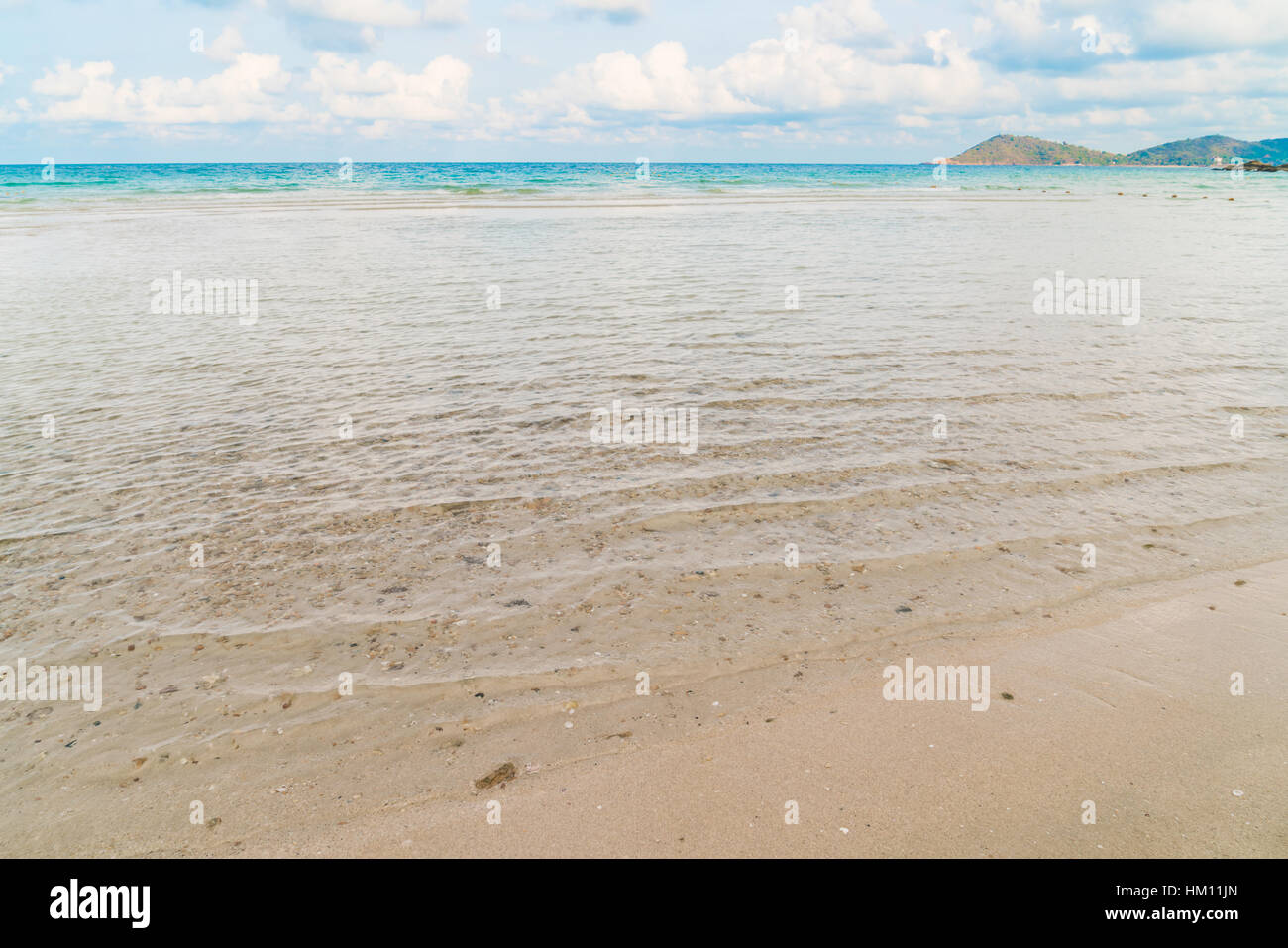 Beautiful white sand beach with blue sea and sky Stock Photo - Alamy