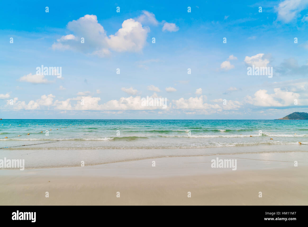Beautiful white sand beach with blue sea and sky Stock Photo - Alamy