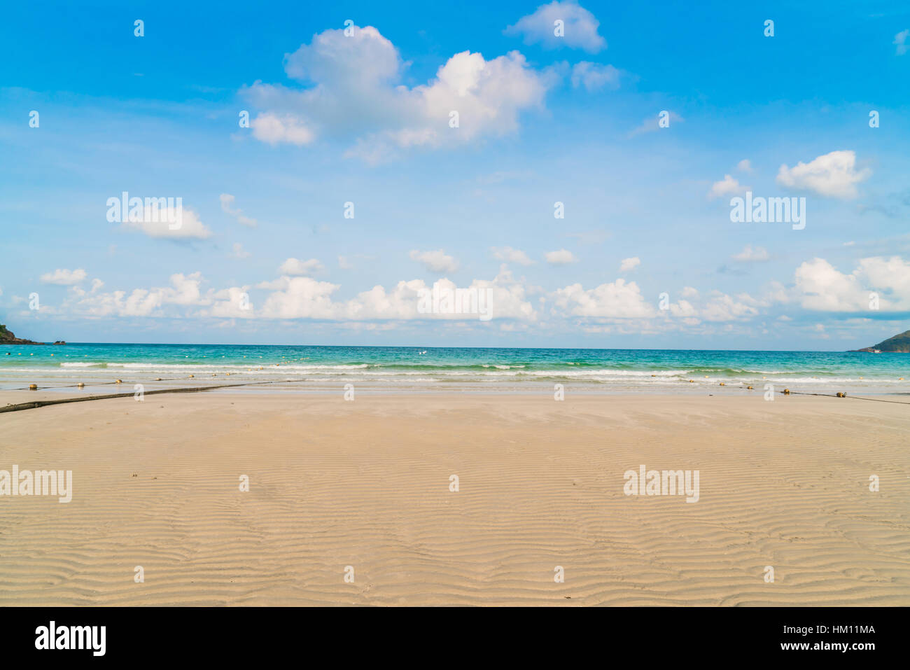Beautiful white sand beach with blue sea and sky Stock Photo - Alamy