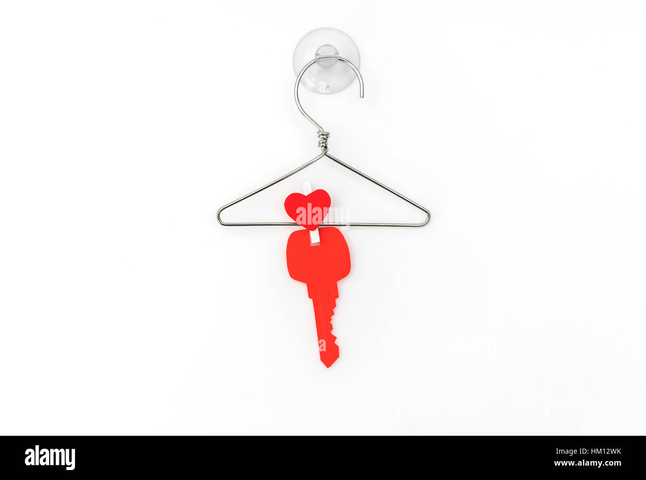 Red paper heart hanging on white background Stock Photo - Alamy
