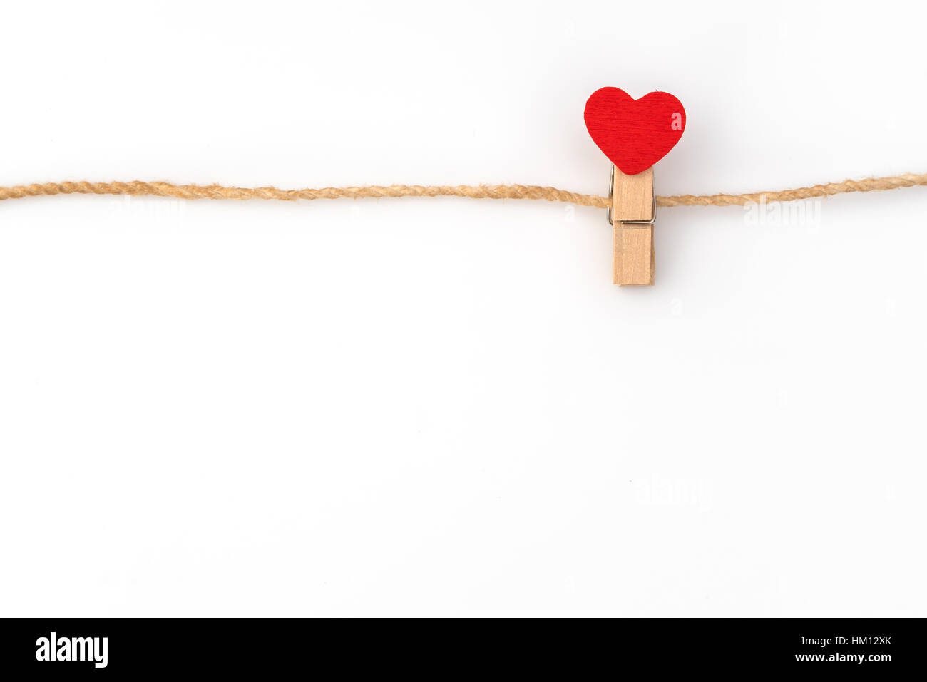 Red paper heart hanging on white background Stock Photo - Alamy