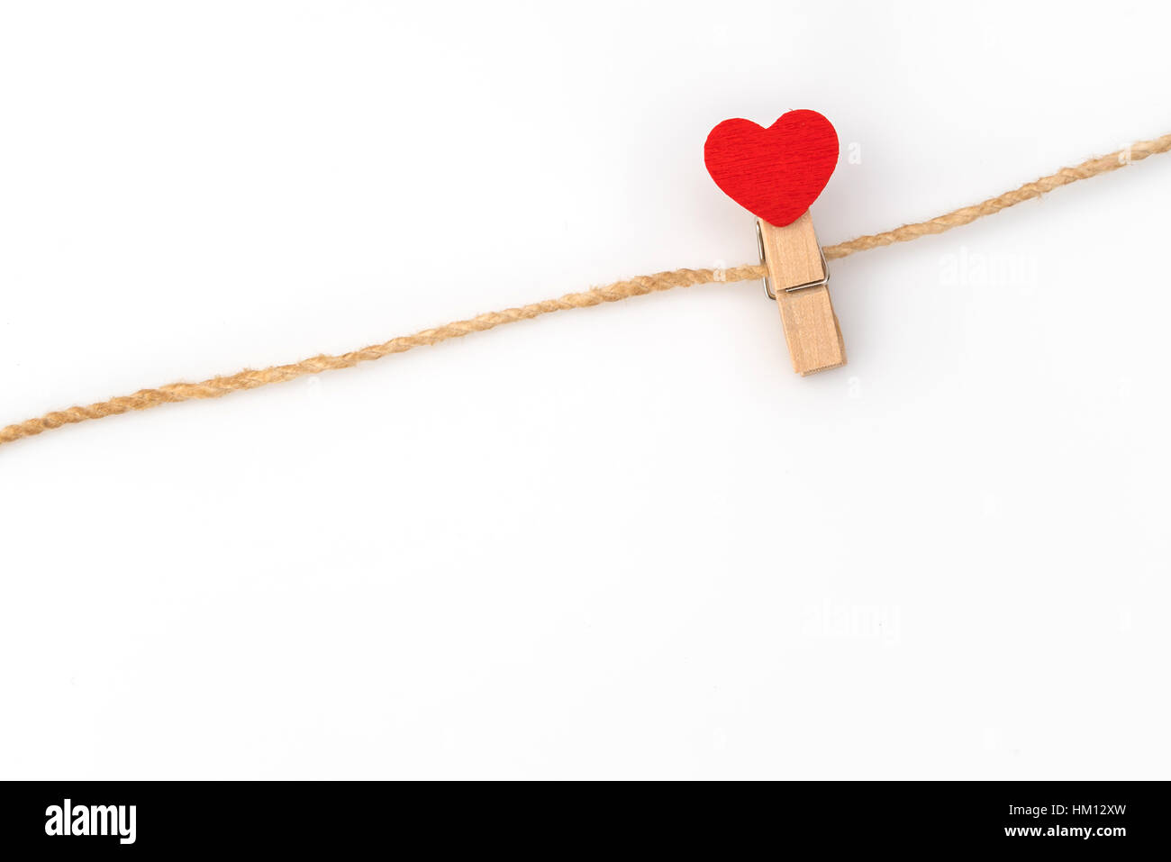 Red paper heart hanging on white background Stock Photo - Alamy