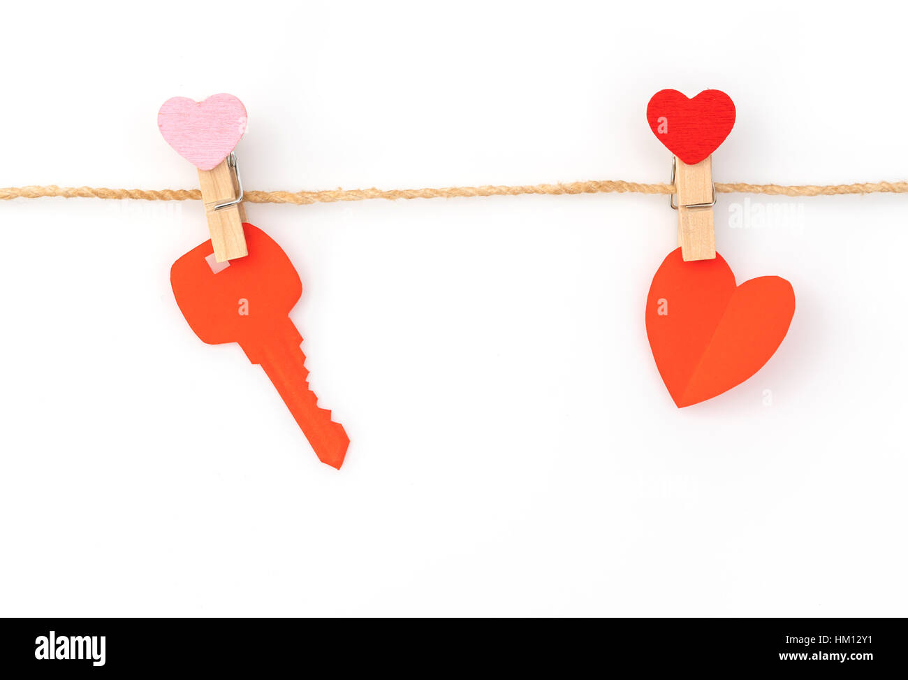 Red paper heart hanging on white background Stock Photo - Alamy