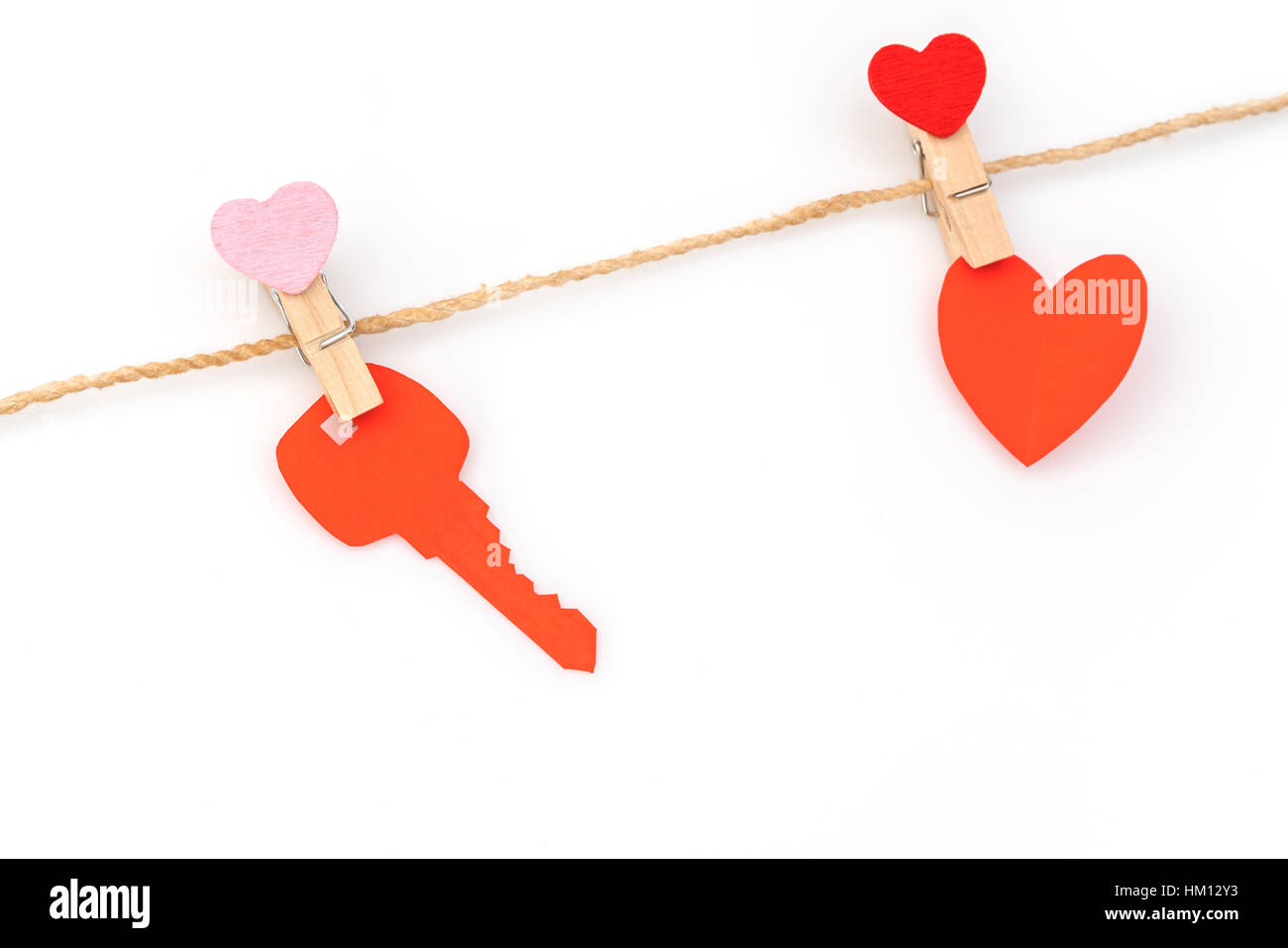 Red paper heart hanging on white background Stock Photo - Alamy