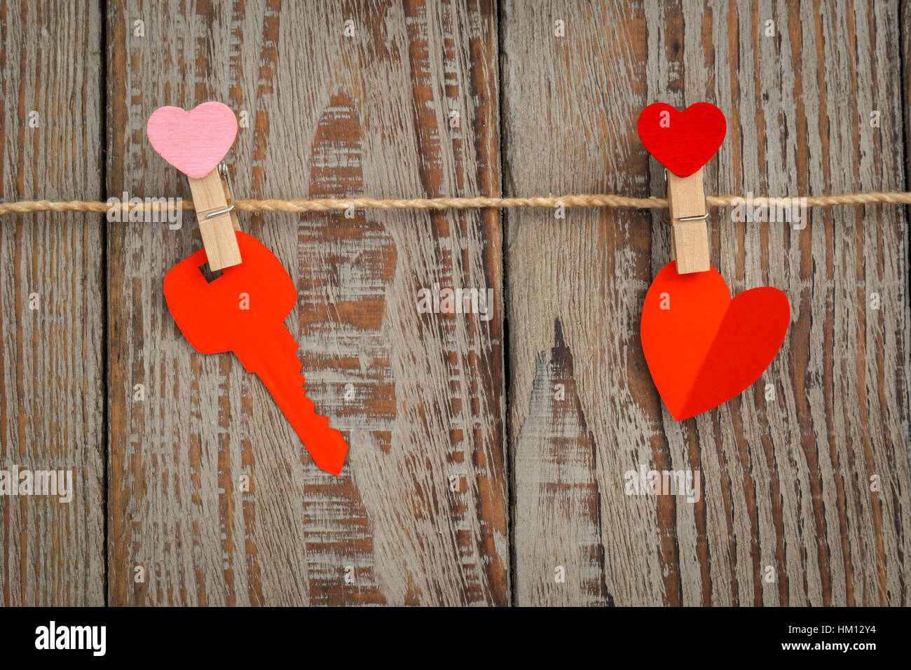 Red paper heart hanging on wood background Stock Photo - Alamy
