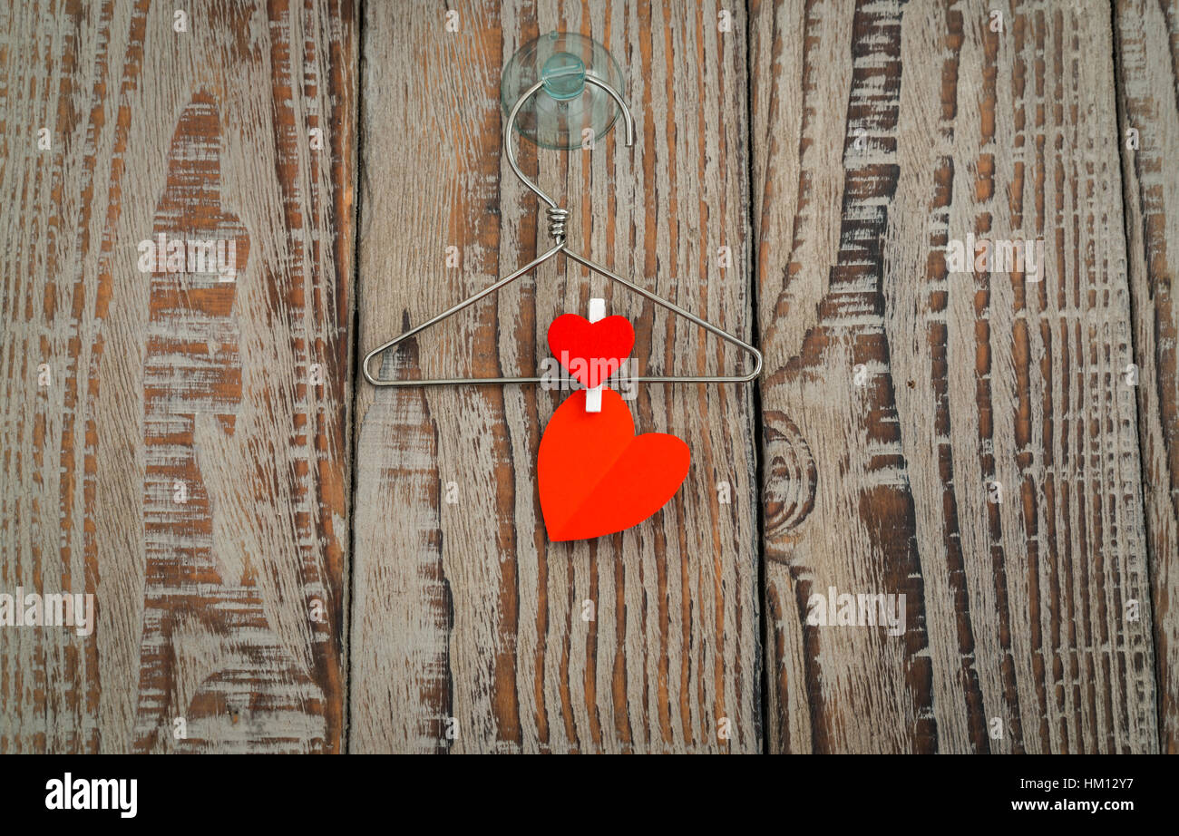 Red paper heart hanging on wood background Stock Photo - Alamy