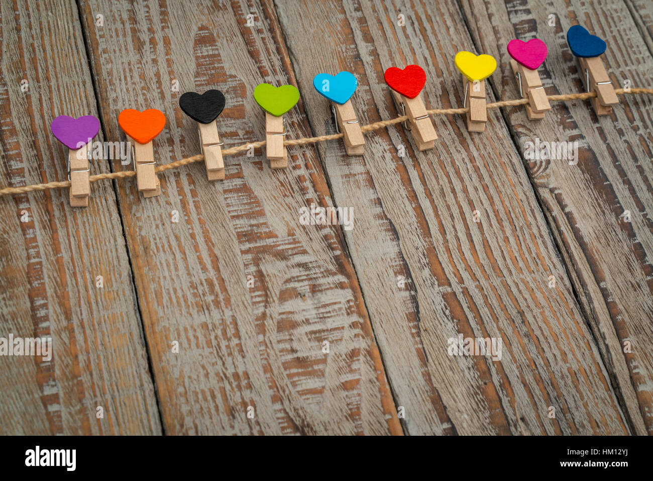 Red paper heart hanging on wood background Stock Photo - Alamy