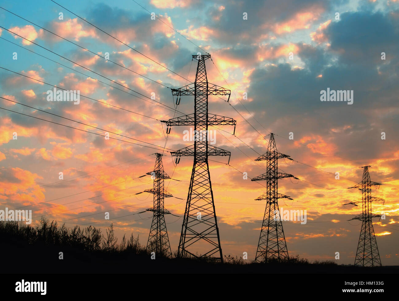 high voltage power transmission line. Silhouette electricity post on ...