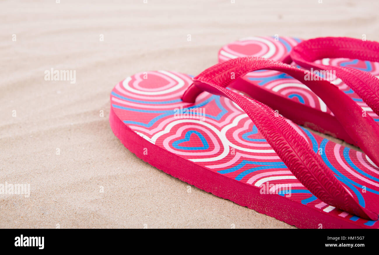 Flipflops on sand beach Stock Photo - Alamy