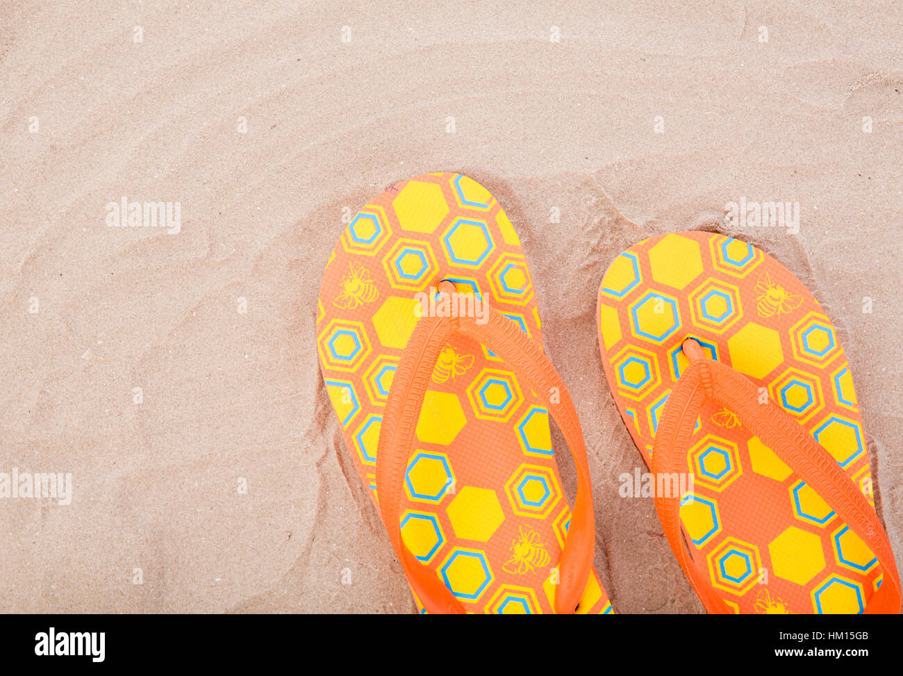 Flipflops on sand beach Stock Photo - Alamy