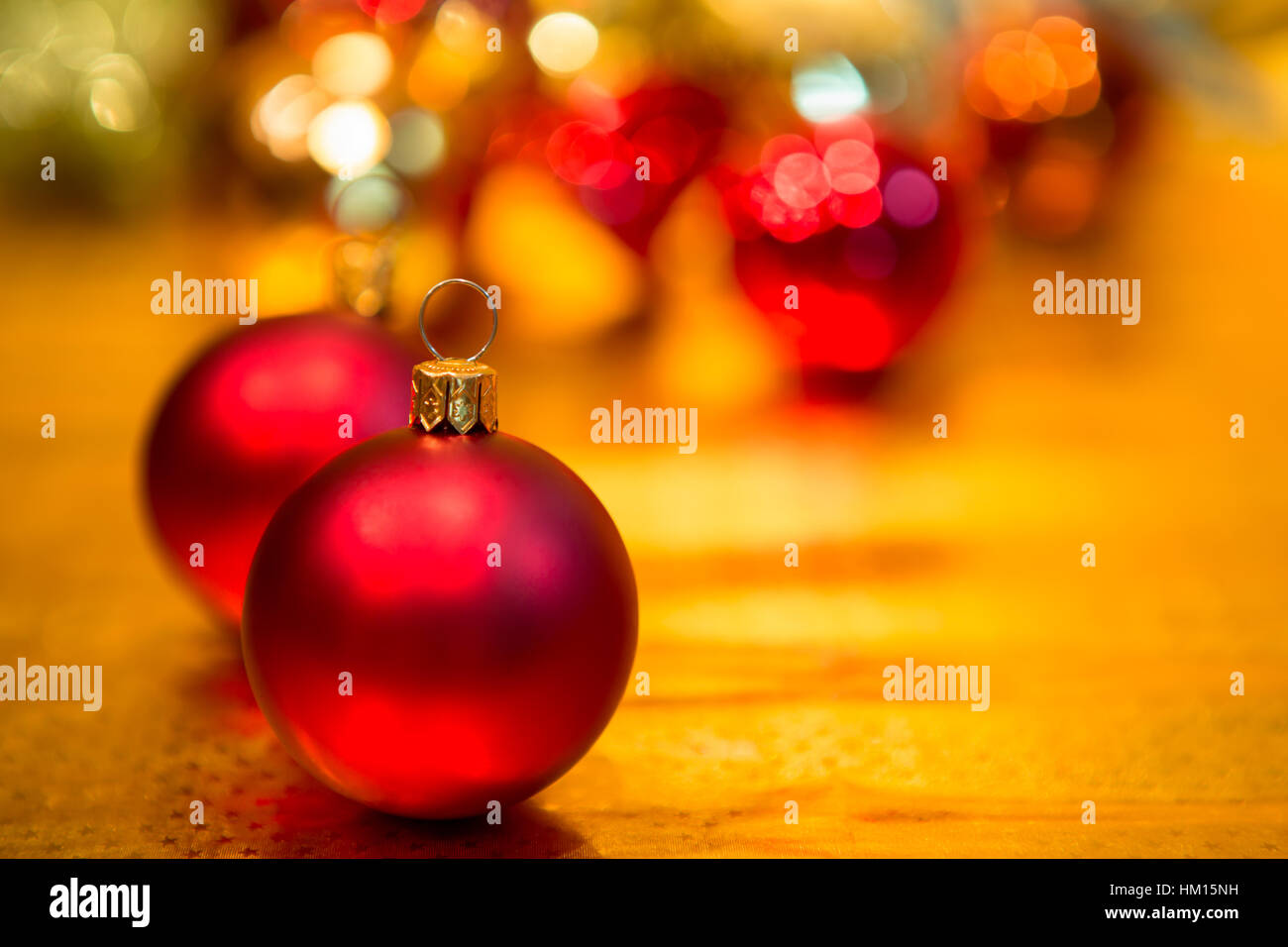 Red Christmas balls on a gold background Stock Photo - Alamy