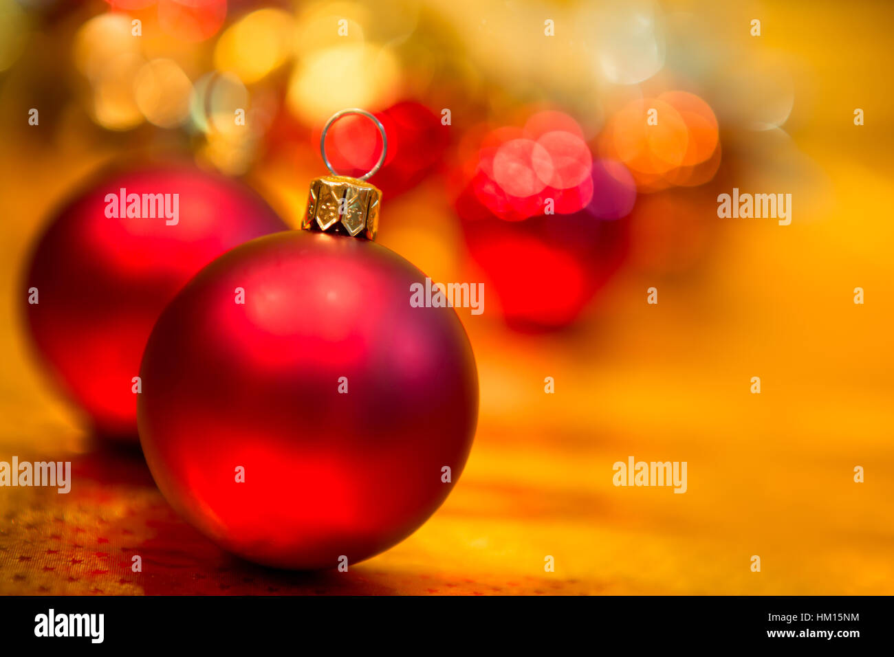 Red Christmas balls on a gold background Stock Photo - Alamy