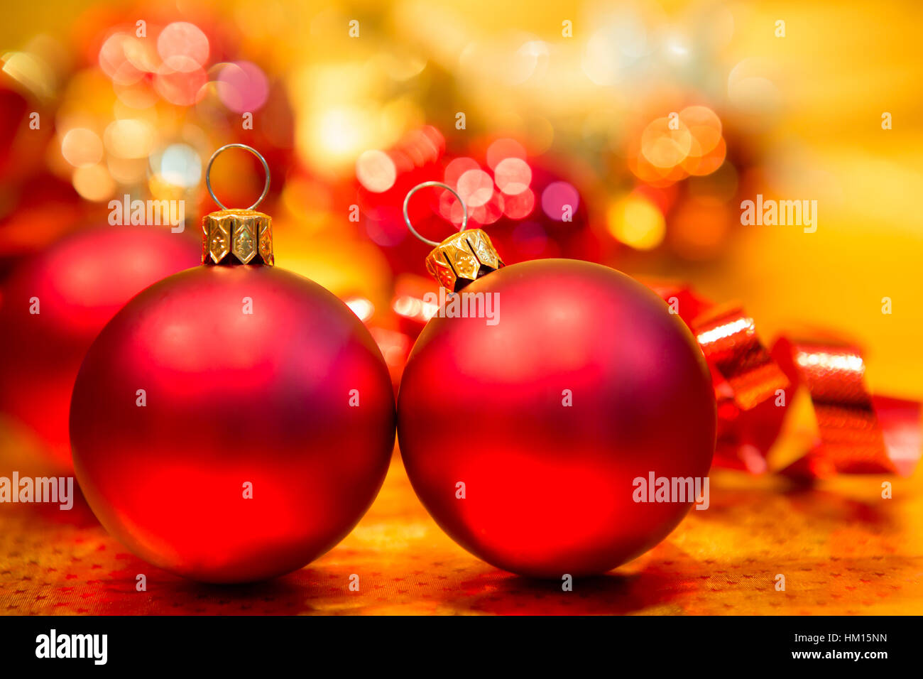 Red Christmas balls on a gold background Stock Photo - Alamy