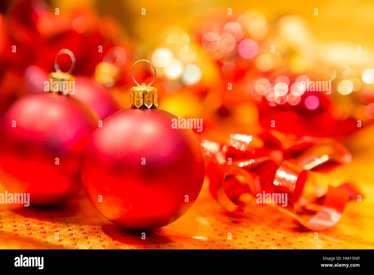 Red Christmas balls on a gold background Stock Photo - Alamy