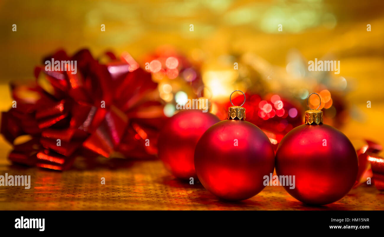 Red Christmas balls on a gold background Stock Photo - Alamy